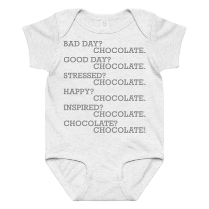 "Bad Day? Chocolate. Good Day? Chocolate. Stressed? Chocolate. Happy? Chocolate. Inspired? Chocolate. Chocolate? Chocolate!" printed on a ash baby jersey bodysuit laying on a flat surface amongst other clothes