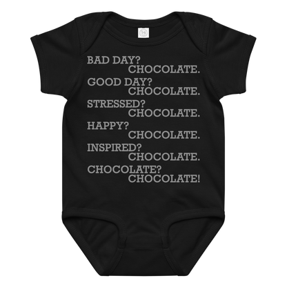 "Bad Day? Chocolate. Good Day? Chocolate. Stressed? Chocolate. Happy? Chocolate. Inspired? Chocolate. Chocolate? Chocolate!" printed on a black baby jersey bodysuit laying on a flat surface amongst other clothes