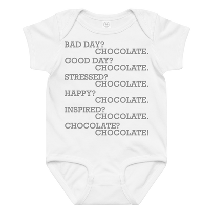 "Bad Day? Chocolate. Good Day? Chocolate. Stressed? Chocolate. Happy? Chocolate. Inspired? Chocolate. Chocolate? Chocolate!" printed on a white baby jersey bodysuit laying on a flat surface amongst other clothes
