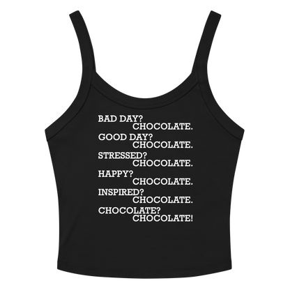 "Bad Day? Chocolate. Good Day? Chocolate. Stressed? Chocolate. Happy? Chocolate. Inspired? Chocolate. Chocolate? Chocolate!" printed on a solid black blend women's micro-rib tanktop laying on a flat surface amongst sunglasses and shorts