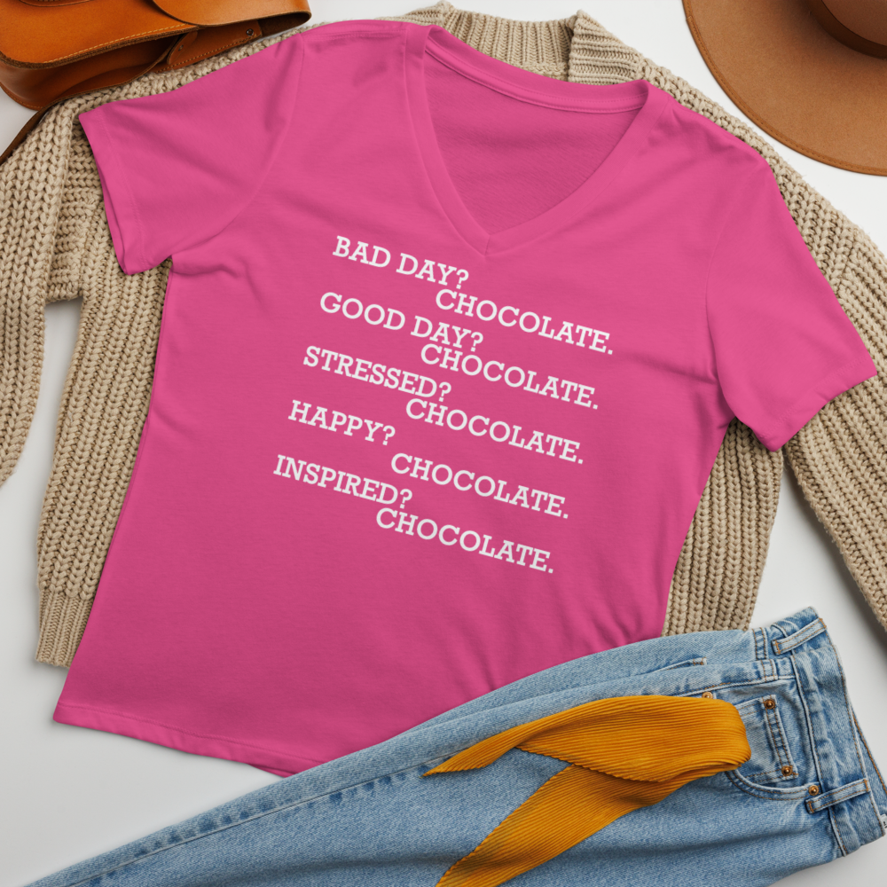 "Bad Day? Chocolate. Good Day? Chocolate. Stressed? Chocolate. Happy? Chocolate. Inspired? Chocolate. Chocolate? Chocolate!" printed on a berry women's relaxed v-neck t-shirt laying on a flat surface amongst other clothes
