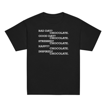"Bad Day? Chocolate. Good Day? Chocolate. Stressed? Chocolate. Happy? Chocolate. Inspired? Chocolate. Chocolate? Chocolate!" printed on a black youth classic tee laying on a flat surface