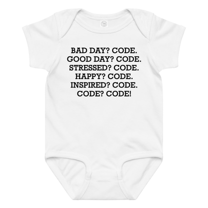"Bad Day? Code. Good Day? Code. Stressed? Code. Happy? Code. Inspired? Code. Code? Code!" printed on a white baby jersey bodysuit laying on a flat surface amongst other clothes