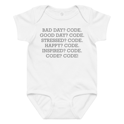 "Bad Day? Code. Good Day? Code. Stressed? Code. Happy? Code. Inspired? Code. Code? Code!" printed on a white baby jersey bodysuit laying on a flat surface amongst other clothes