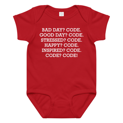 "Bad Day? Code. Good Day? Code. Stressed? Code. Happy? Code. Inspired? Code. Code? Code!" printed on a red baby jersey bodysuit laying on a flat surface amongst other clothes
