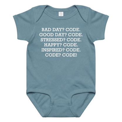 "Bad Day? Code. Good Day? Code. Stressed? Code. Happy? Code. Inspired? Code. Code? Code!" printed on a vintage indigo baby jersey bodysuit laying on a flat surface amongst other clothes