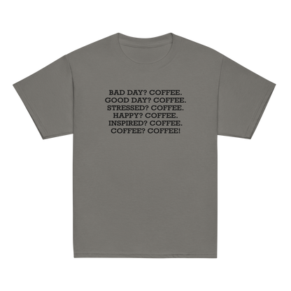 "Bad Day? Coffee. Good Day? Coffee. Stressed? Coffee. Happy? Coffee. Inspired? Coffee. Coffee? Coffee!" printed on a charcoal youth classic tee laying on a flat surface