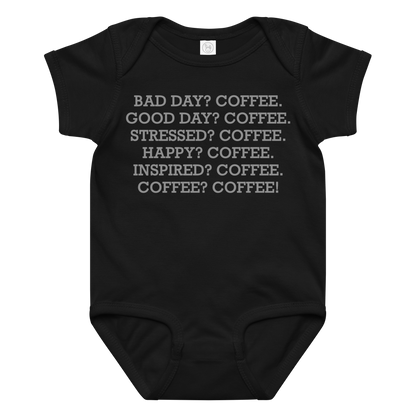 "Bad Day? Coffee. Good Day? Coffee. Stressed? Coffee. Happy? Coffee. Inspired? Coffee. Coffee? Coffee!" printed on a black baby jersey bodysuit laying on a flat surface amongst other clothes