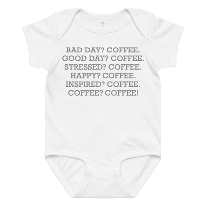 "Bad Day? Coffee. Good Day? Coffee. Stressed? Coffee. Happy? Coffee. Inspired? Coffee. Coffee? Coffee!" printed on a white baby jersey bodysuit laying on a flat surface amongst other clothes