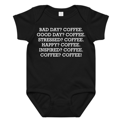 "Bad Day? Coffee. Good Day? Coffee. Stressed? Coffee. Happy? Coffee. Inspired? Coffee. Coffee? Coffee!" printed on a black baby jersey bodysuit laying on a flat surface amongst other clothes