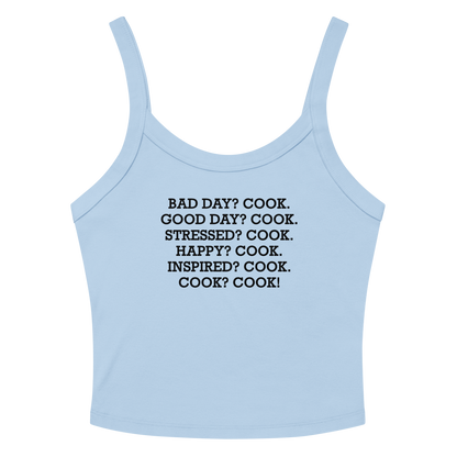 "Bad Day? Cook. Good Day? Cook. Stressed? Cook. Happy? Cook. Inspired? Cook. Cook? Cook!" printed on a solid baby blue blend women's micro-rib tanktop laying on a flat surface amongst sunglasses and shorts