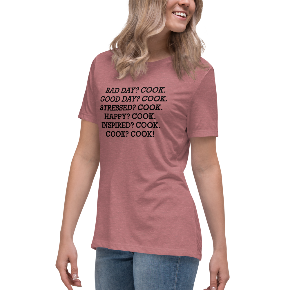 "Bad Day? Cook. Good Day? Cook. Stressed? Cook. Happy? Cook. Inspired? Cook. Cook? Cook!" printed on a heather mauve women's relaxed t-shirt worn by a female