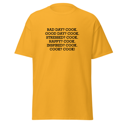 "Bad Day? Cook. Good Day? Cook. Stressed? Cook. Happy? Cook. Inspired? Cook. Cook? Cook!" printed on a gold on an invisible body
