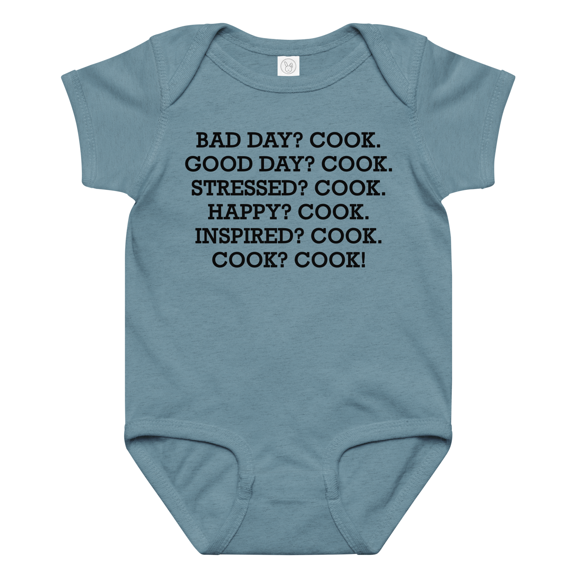 "Bad Day? Cook. Good Day? Cook. Stressed? Cook. Happy? Cook. Inspired? Cook. Cook? Cook!" printed on a vintage indigo baby jersey bodysuit laying on a flat surface amongst other clothes