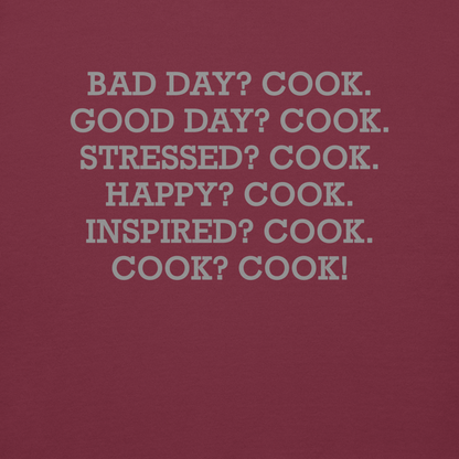 "Bad Day? Cook. Good Day? Cook. Stressed? Cook. Happy? Cook. Inspired? Cook. Cook? Cook!" printed on a maroon background