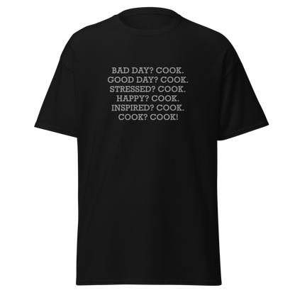 "Bad Day? Cook. Good Day? Cook. Stressed? Cook. Happy? Cook. Inspired? Cook. Cook? Cook!" printed on a black on an invisible body