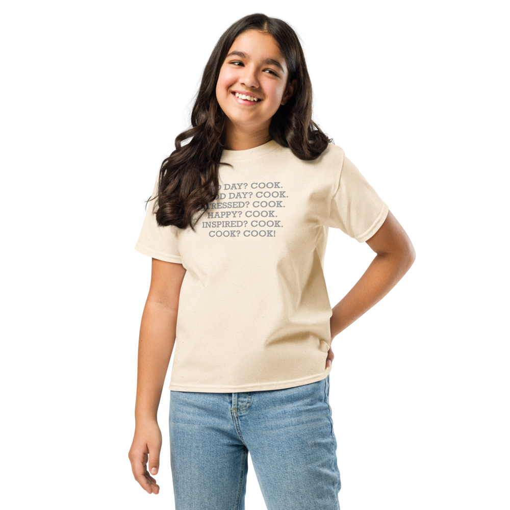 "Bad Day? Cook. Good Day? Cook. Stressed? Cook. Happy? Cook. Inspired? Cook. Cook? Cook!" printed on a natural youth classic tee worn by a female