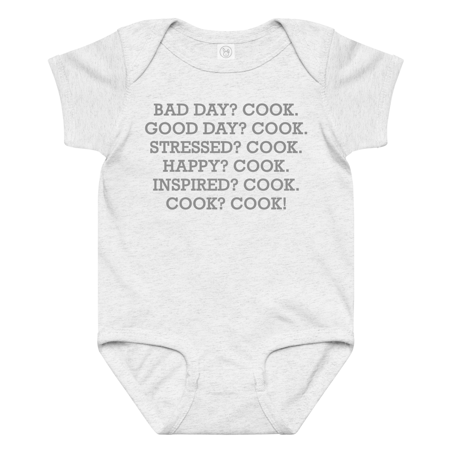 "Bad Day? Cook. Good Day? Cook. Stressed? Cook. Happy? Cook. Inspired? Cook. Cook? Cook!" printed on a ash baby jersey bodysuit laying on a flat surface amongst other clothes
