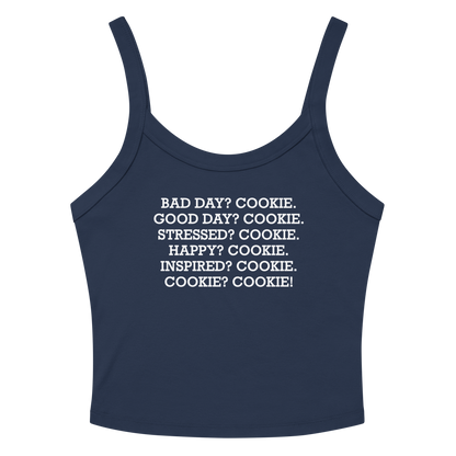 "Bad Day? Cook. Good Day? Cook. Stressed? Cook. Happy? Cook. Inspired? Cook. Cook? Cook!" printed on a solid navy blend women's micro-rib tanktop laying on a flat surface amongst sunglasses and shorts