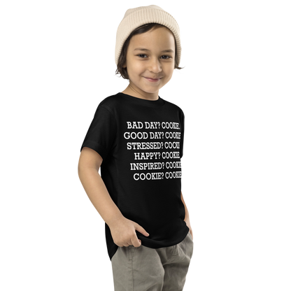 "Bad Day? Cook. Good Day? Cook. Stressed? Cook. Happy? Cook. Inspired? Cook. Cook? Cook!" printed on a black toddler short sleeve tee worn by a male who is also wearing a knit cap