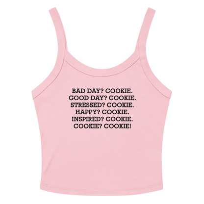"Bad Day? Cookie. Good Day? Cookie. Stressed? Cookie. Happy? Cookie. Inspired? Cookie. Cookie? Cookie!" printed on a solid pink blend women's micro-rib tanktop laying on a flat surface amongst sunglasses and shorts
