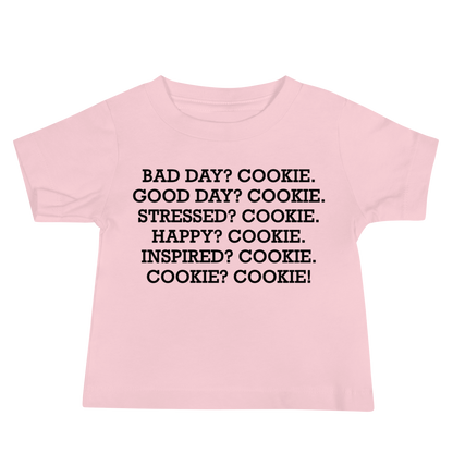 "Bad Day? Cookie. Good Day? Cookie. Stressed? Cookie. Happy? Cookie. Inspired? Cookie. Cookie? Cookie!" printed on a pink baby jersey short sleeve tee laying on a flat surface