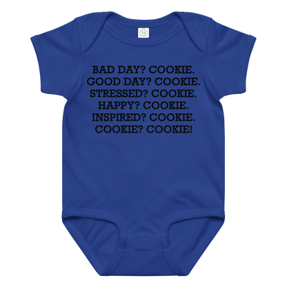 "Bad Day? Cookie. Good Day? Cookie. Stressed? Cookie. Happy? Cookie. Inspired? Cookie. Cookie? Cookie!" printed on a royal baby jersey bodysuit laying on a flat surface amongst other clothes