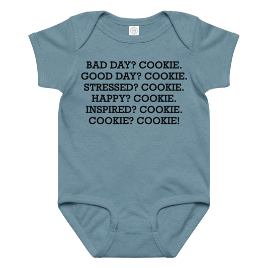 "Bad Day? Cookie. Good Day? Cookie. Stressed? Cookie. Happy? Cookie. Inspired? Cookie. Cookie? Cookie!" printed on a vintage indigo baby jersey bodysuit laying on a flat surface amongst other clothes