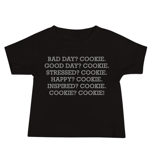 "Bad Day? Cookie. Good Day? Cookie. Stressed? Cookie. Happy? Cookie. Inspired? Cookie. Cookie? Cookie!" printed on a black baby jersey short sleeve tee laying on a flat surface