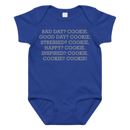 "Bad Day? Cookie. Good Day? Cookie. Stressed? Cookie. Happy? Cookie. Inspired? Cookie. Cookie? Cookie!" printed on a royal baby jersey bodysuit laying on a flat surface amongst other clothes