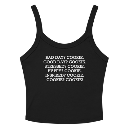"Bad Day? Cookie. Good Day? Cookie. Stressed? Cookie. Happy? Cookie. Inspired? Cookie. Cookie? Cookie!" printed on a solid black blend women's micro-rib tanktop laying on a flat surface amongst sunglasses and shorts
