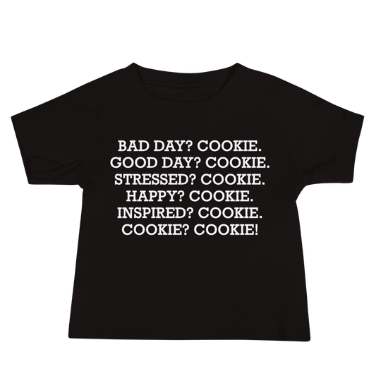 "Bad Day? Cookie. Good Day? Cookie. Stressed? Cookie. Happy? Cookie. Inspired? Cookie. Cookie? Cookie!" printed on a black baby jersey short sleeve tee laying on a flat surface