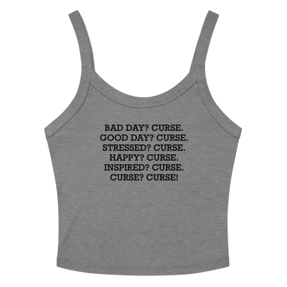 "Bad Day? Curse. Good Day? Curse. Stressed? Curse. Happy? Curse. Inspired? Curse. Curse? Curse!" printed on a athletic heather women's micro-rib tanktop laying on a flat surface amongst sunglasses and shorts