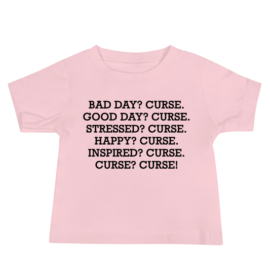 "Bad Day? Curse. Good Day? Curse. Stressed? Curse. Happy? Curse. Inspired? Curse. Curse? Curse!" printed on a pink baby jersey short sleeve tee laying on a flat surface