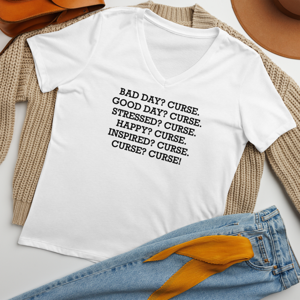 "Bad Day? Curse. Good Day? Curse. Stressed? Curse. Happy? Curse. Inspired? Curse. Curse? Curse!" printed on a solid white blend women's relaxed v-neck t-shirt laying on a flat surface amongst other clothes