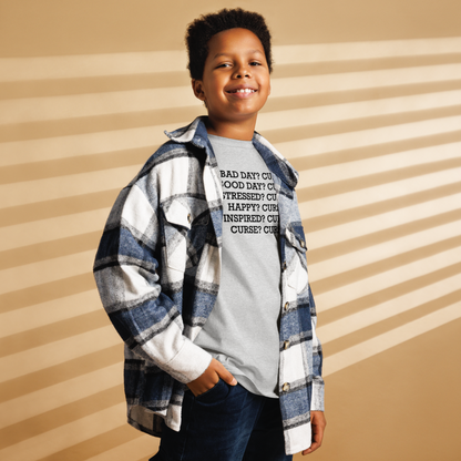 "Bad Day? Curse. Good Day? Curse. Stressed? Curse. Happy? Curse. Inspired? Curse. Curse? Curse!" printed on a sport grey youth classic tee worn by a male also wearing a jacket