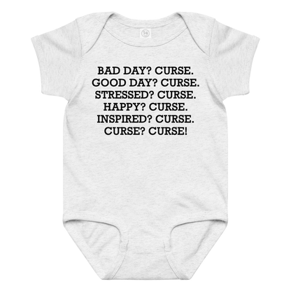 "Bad Day? Curse. Good Day? Curse. Stressed? Curse. Happy? Curse. Inspired? Curse. Curse? Curse!" printed on a ash baby jersey bodysuit laying on a flat surface amongst other clothes