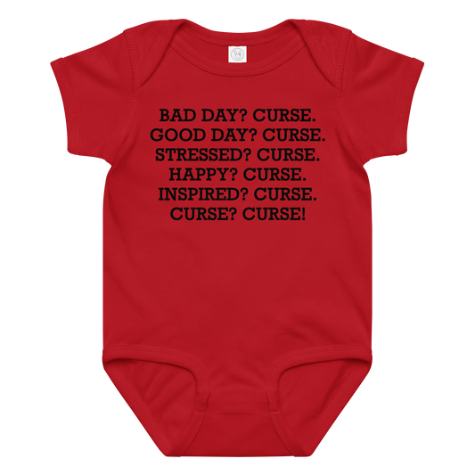 "Bad Day? Curse. Good Day? Curse. Stressed? Curse. Happy? Curse. Inspired? Curse. Curse? Curse!" printed on a red baby jersey bodysuit laying on a flat surface amongst other clothes