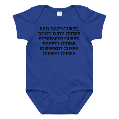 "Bad Day? Curse. Good Day? Curse. Stressed? Curse. Happy? Curse. Inspired? Curse. Curse? Curse!" printed on a royal baby jersey bodysuit laying on a flat surface amongst other clothes