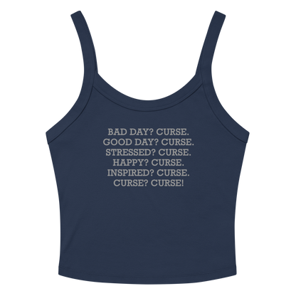 "Bad Day? Curse. Good Day? Curse. Stressed? Curse. Happy? Curse. Inspired? Curse. Curse? Curse!" printed on a solid navy blend women's micro-rib tanktop laying on a flat surface amongst sunglasses and shorts