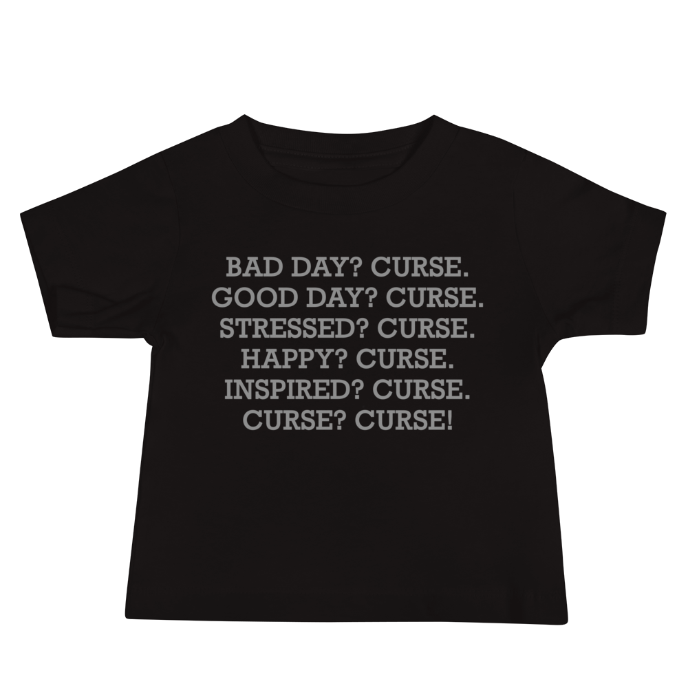 "Bad Day? Curse. Good Day? Curse. Stressed? Curse. Happy? Curse. Inspired? Curse. Curse? Curse!" printed on a black baby jersey short sleeve tee laying on a flat surface
