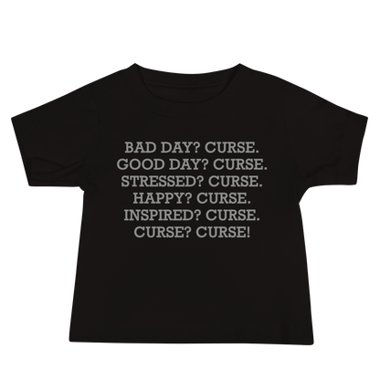 "Bad Day? Curse. Good Day? Curse. Stressed? Curse. Happy? Curse. Inspired? Curse. Curse? Curse!" printed on a black baby jersey short sleeve tee laying on a flat surface