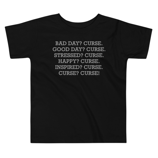 "Bad Day? Curse. Good Day? Curse. Stressed? Curse. Happy? Curse. Inspired? Curse. Curse? Curse!" printed on a black toddler short sleeve tee laying on a flat surface