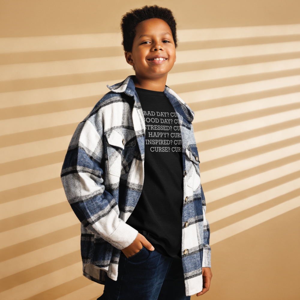 "Bad Day? Curse. Good Day? Curse. Stressed? Curse. Happy? Curse. Inspired? Curse. Curse? Curse!" printed on a black youth classic tee worn by a male also wearing a jacket