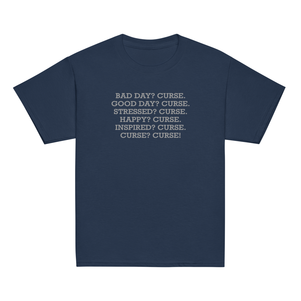 "Bad Day? Curse. Good Day? Curse. Stressed? Curse. Happy? Curse. Inspired? Curse. Curse? Curse!" printed on a navy youth classic tee laying on a flat surface