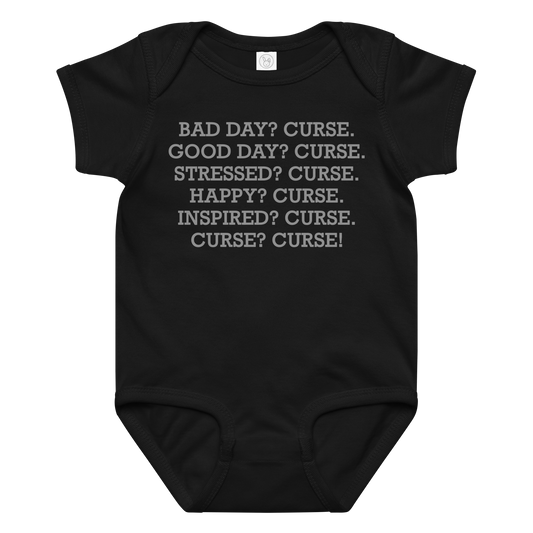 "Bad Day? Curse. Good Day? Curse. Stressed? Curse. Happy? Curse. Inspired? Curse. Curse? Curse!" printed on a black baby jersey bodysuit laying on a flat surface amongst other clothes