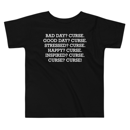 "Bad Day? Curse. Good Day? Curse. Stressed? Curse. Happy? Curse. Inspired? Curse. Curse? Curse!" printed on a black toddler short sleeve tee laying on a flat surface