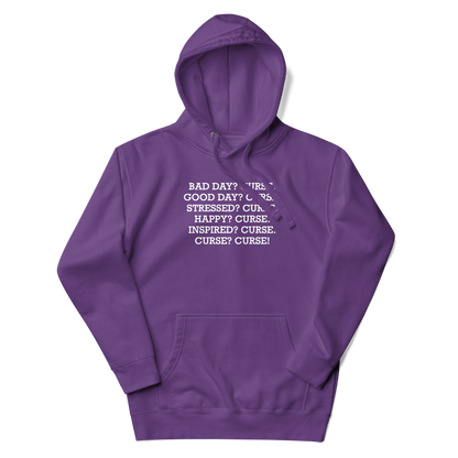 "Bad Day? Curse. Good Day? Curse. Stressed? Curse. Happy? Curse. Inspired? Curse. Curse? Curse!" printed on a purple unisex hoodie laying on a flat surface with the hood up
