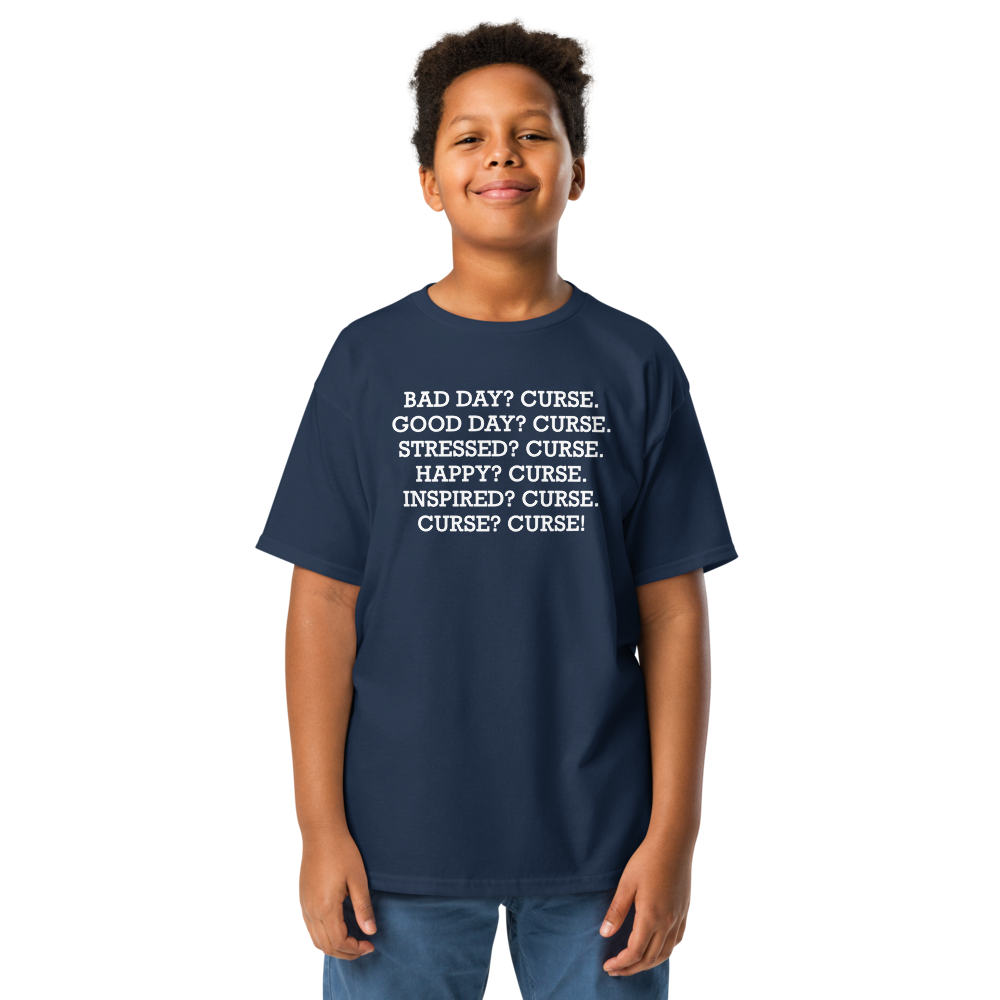"Bad Day? Curse. Good Day? Curse. Stressed? Curse. Happy? Curse. Inspired? Curse. Curse? Curse!" printed on a navy youth classic tee worn by a male