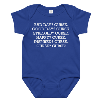 "Bad Day? Curse. Good Day? Curse. Stressed? Curse. Happy? Curse. Inspired? Curse. Curse? Curse!" printed on a royal baby jersey bodysuit laying on a flat surface amongst other clothes